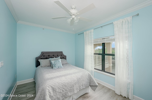 bedroom featuring ornamental molding, wood-type flooring, and ceiling fan