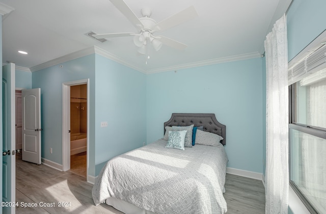 bedroom with ornamental molding, ceiling fan, light hardwood / wood-style flooring, and ensuite bathroom