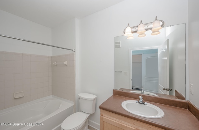 full bathroom with vanity, toilet, and tiled shower / bath