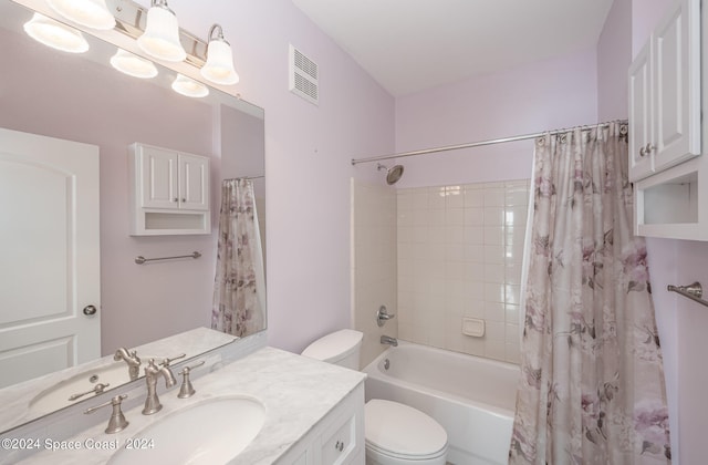 full bathroom featuring shower / bath combo with shower curtain, vanity, and toilet