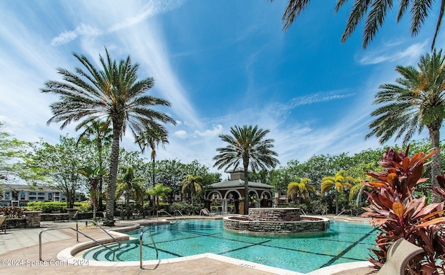 view of pool featuring a hot tub, a patio area, and a gazebo