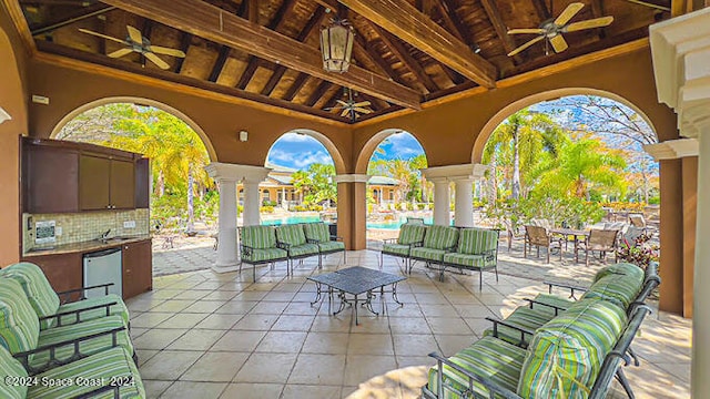 view of patio featuring ceiling fan and a community pool