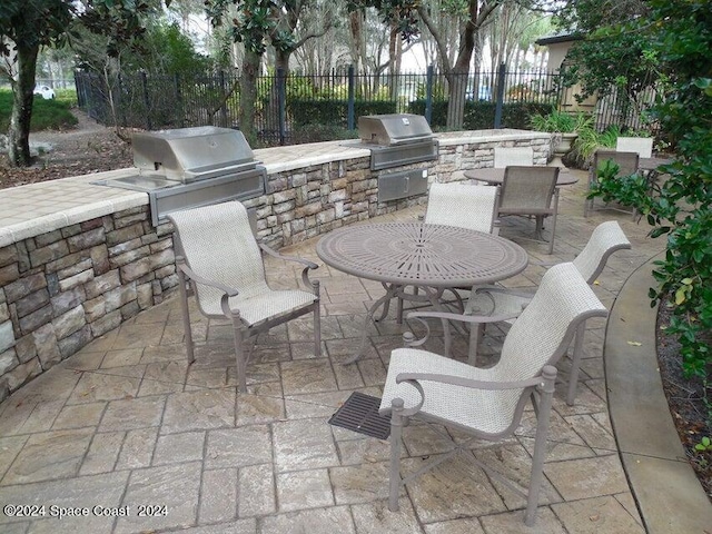 view of patio with grilling area and an outdoor kitchen