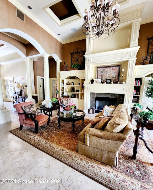 living room featuring a tile fireplace, decorative columns, and ornamental molding