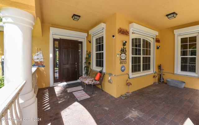 8053 S Indian River Dr, Ft Pierce, FL 34982 - property entrance featuring covered porch and stucco siding