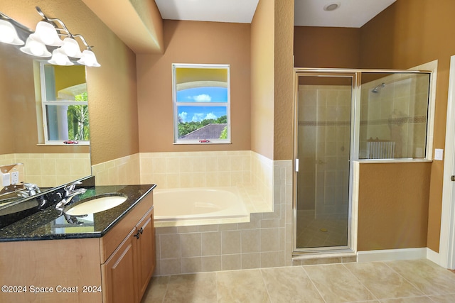 8053 S Indian River Dr, Ft Pierce, FL 34982 - full bathroom featuring vanity, a bath, a stall shower, and tile patterned floors