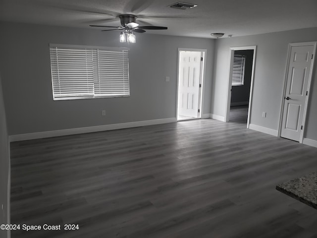 unfurnished room featuring dark hardwood / wood-style flooring and ceiling fan