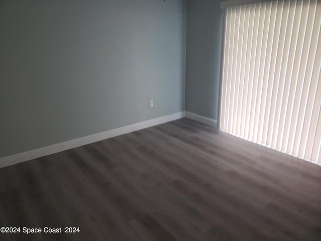 empty room featuring dark hardwood / wood-style flooring