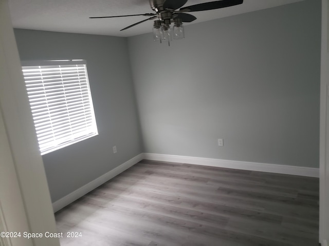 unfurnished room with hardwood / wood-style floors and ceiling fan