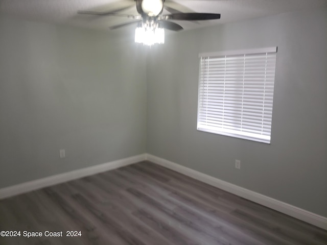 spare room with ceiling fan and dark hardwood / wood-style flooring