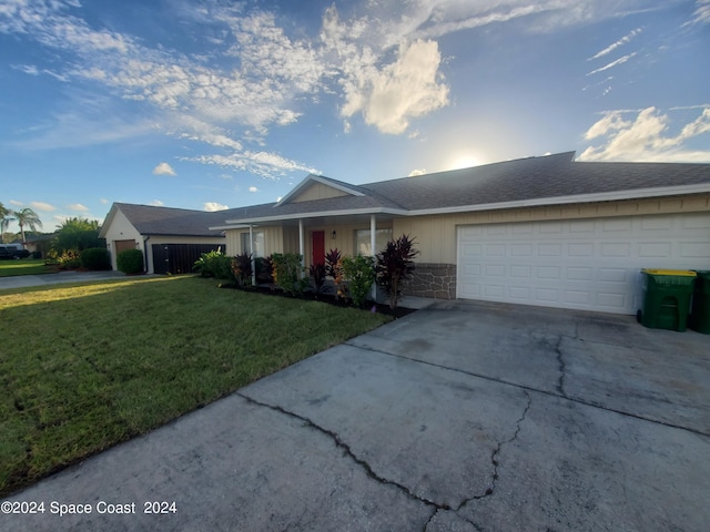 single story home with a front yard and a garage