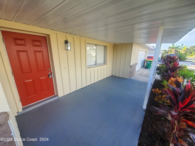 doorway to property featuring a carport