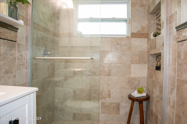 bathroom with an enclosed shower and vanity