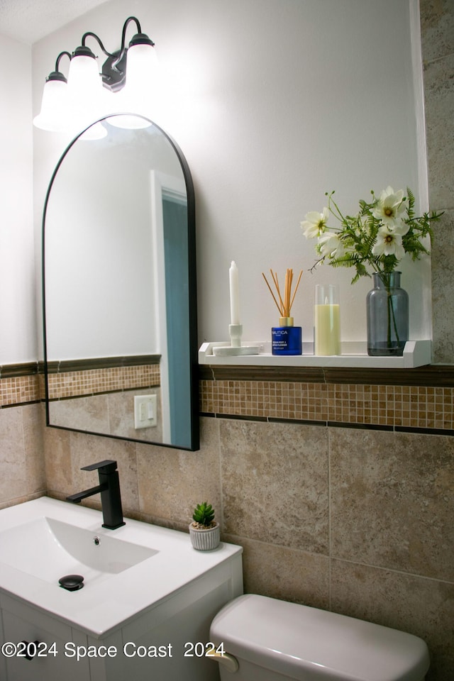 bathroom with backsplash, vanity, and toilet