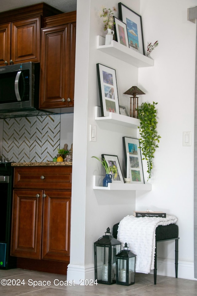 interior space featuring light stone countertops, hardwood / wood-style flooring, and tasteful backsplash