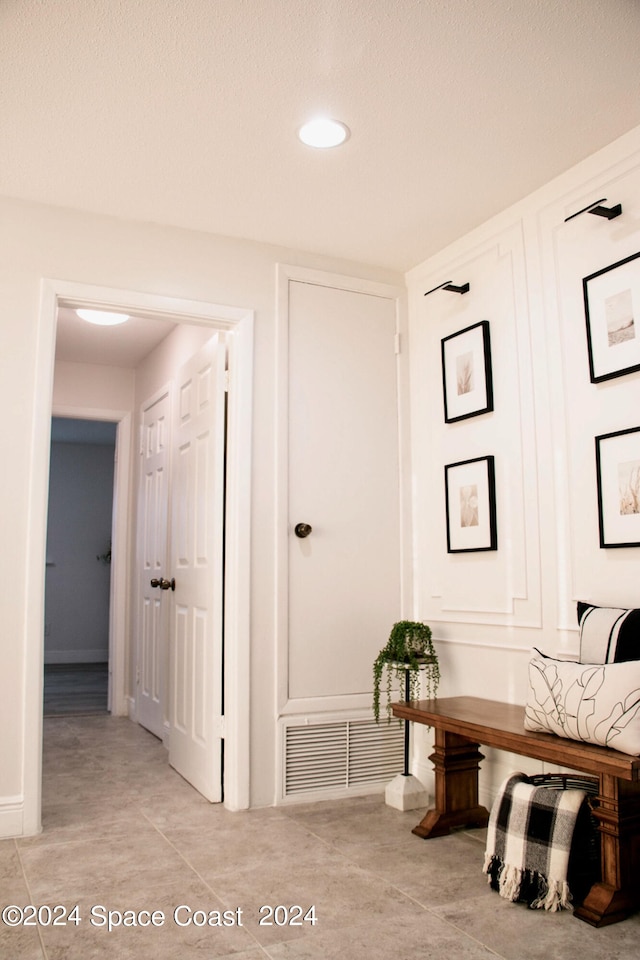 hall featuring a textured ceiling