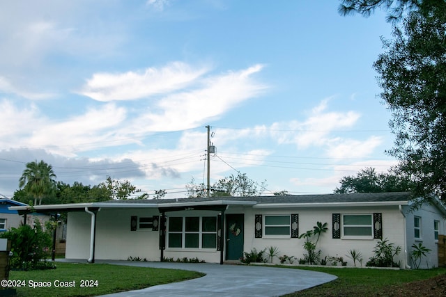 ranch-style home with a front yard