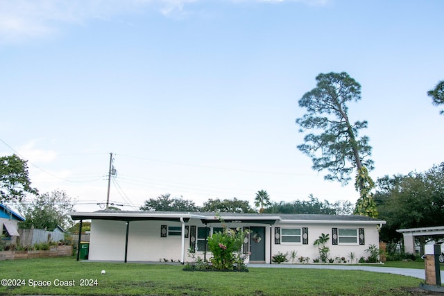 ranch-style house with a front lawn