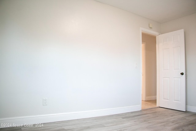 empty room with light hardwood / wood-style flooring