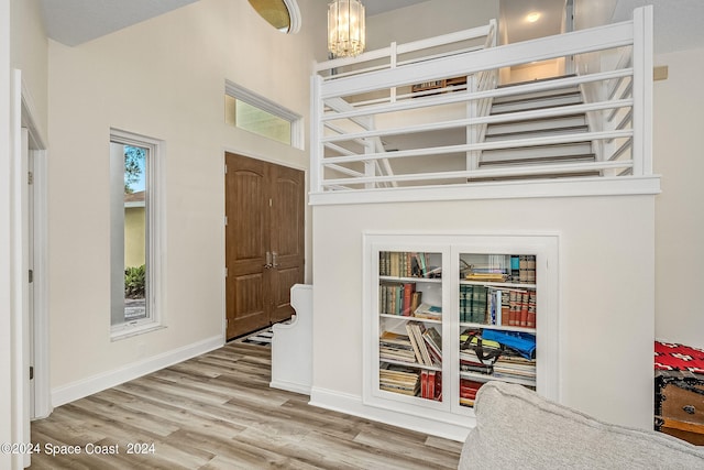 foyer entrance featuring hardwood / wood-style floors and an inviting chandelier