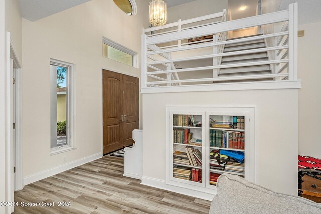1165 Old Parsonage Dr, Merritt Island, FL 32952 - foyer with wood finished floors, a chandelier, and baseboards