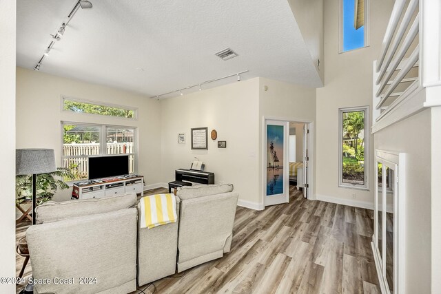 1165 Old Parsonage Dr, Merritt Island, FL 32952 - living room featuring track lighting, light wood-style floors, and baseboards