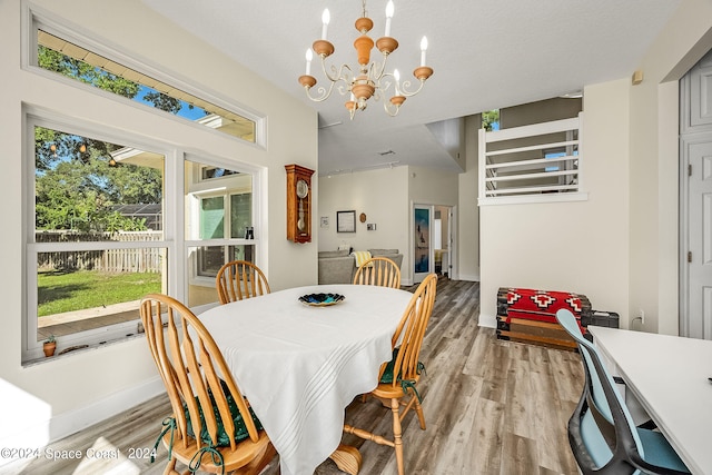 dining space with a chandelier and light wood-type flooring