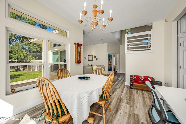 1165 Old Parsonage Dr, Merritt Island, FL 32952 - dining space with light wood finished floors, a chandelier, and baseboards