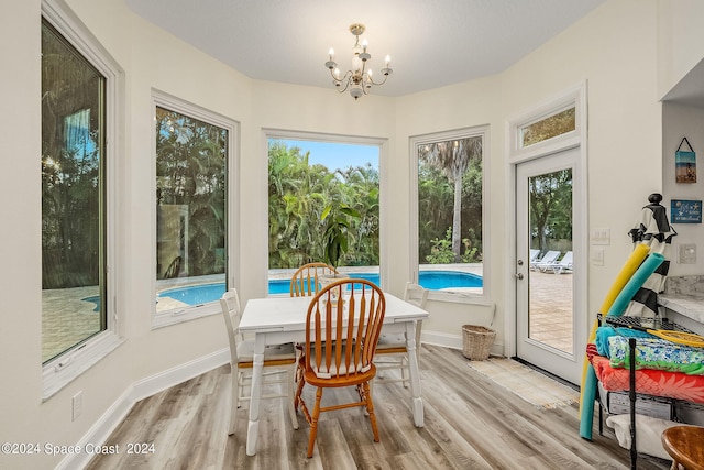 sunroom featuring a chandelier