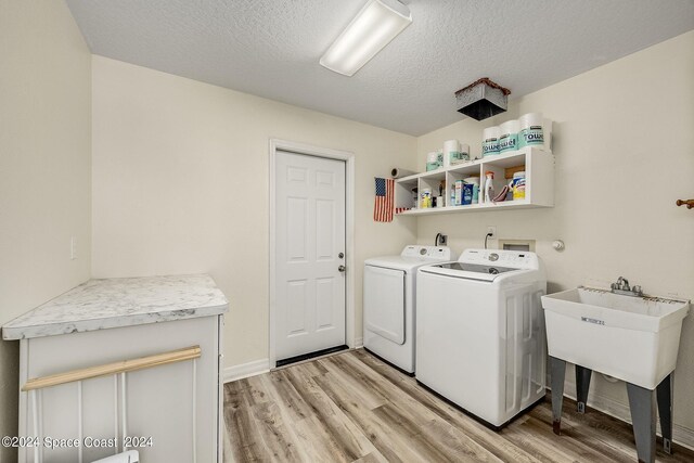 1165 Old Parsonage Dr, Merritt Island, FL 32952 - washroom with washer and dryer, light wood finished floors, and a textured ceiling