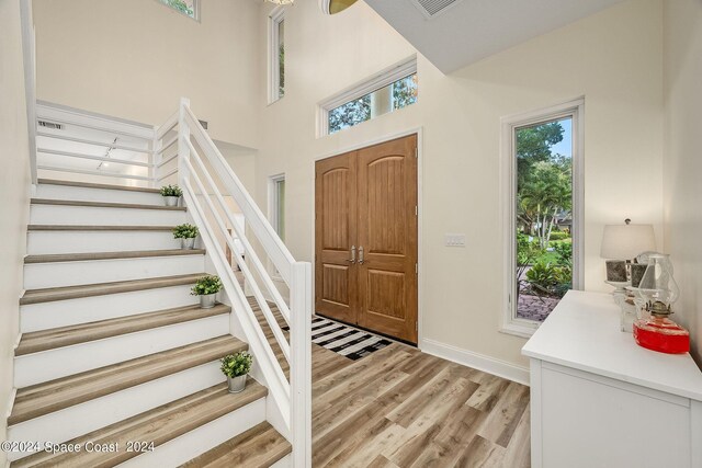 1165 Old Parsonage Dr, Merritt Island, FL 32952 - entryway featuring light wood-style floors, stairway, and baseboards