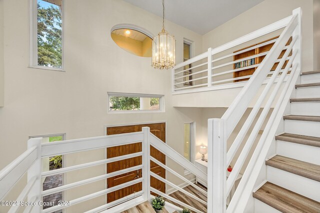 1165 Old Parsonage Dr, Merritt Island, FL 32952 - stairs with a chandelier, plenty of natural light, and a towering ceiling