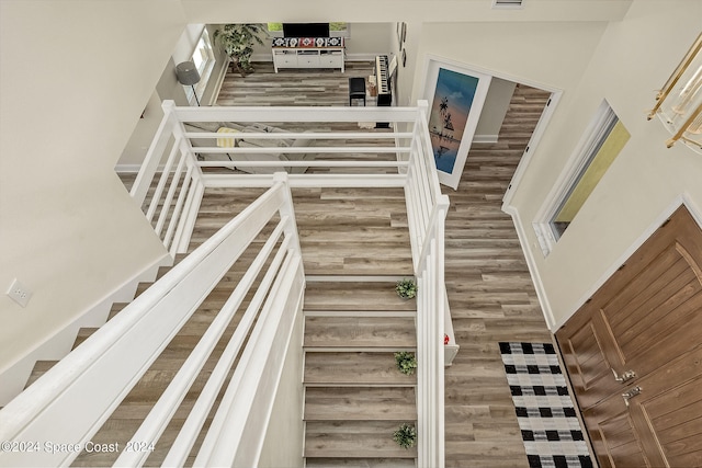 stairs featuring hardwood / wood-style flooring