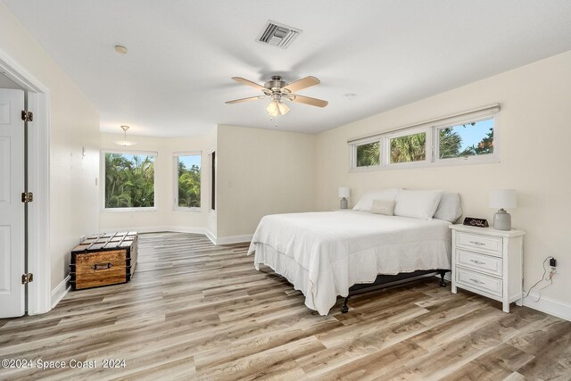 1165 Old Parsonage Dr, Merritt Island, FL 32952 - bedroom featuring baseboards, multiple windows, and wood finished floors
