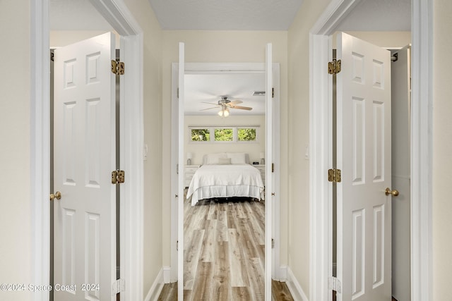 corridor featuring hardwood / wood-style floors