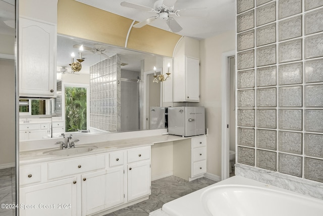 bathroom featuring ceiling fan, separate shower and tub, and vanity