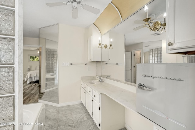 bathroom featuring vanity, a tub to relax in, and hardwood / wood-style flooring