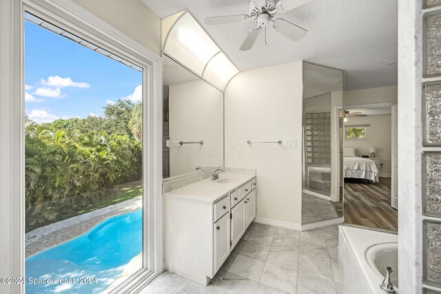 1165 Old Parsonage Dr, Merritt Island, FL 32952 - full bathroom with ceiling fan, ensuite bath, a garden tub, marble look tile flooring, and vanity