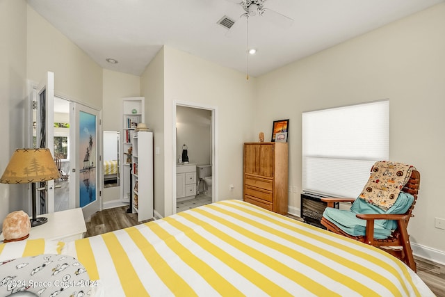 bedroom featuring dark hardwood / wood-style floors, ensuite bathroom, and ceiling fan