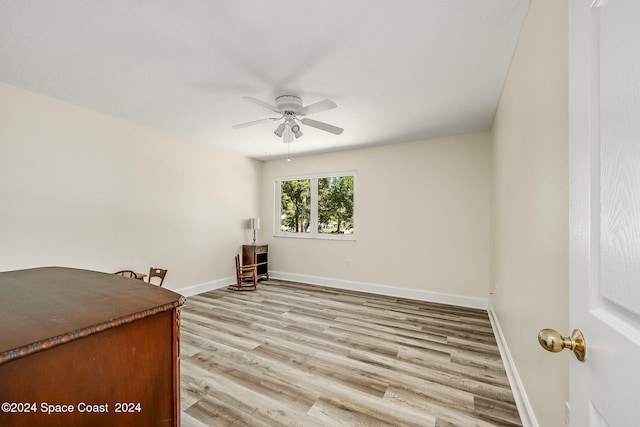 unfurnished room with light wood-type flooring and ceiling fan