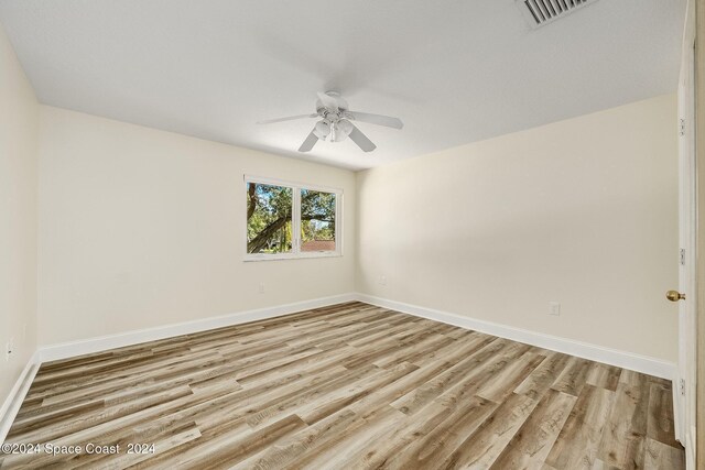 1165 Old Parsonage Dr, Merritt Island, FL 32952 - unfurnished room featuring a ceiling fan, light wood finished floors, and baseboards