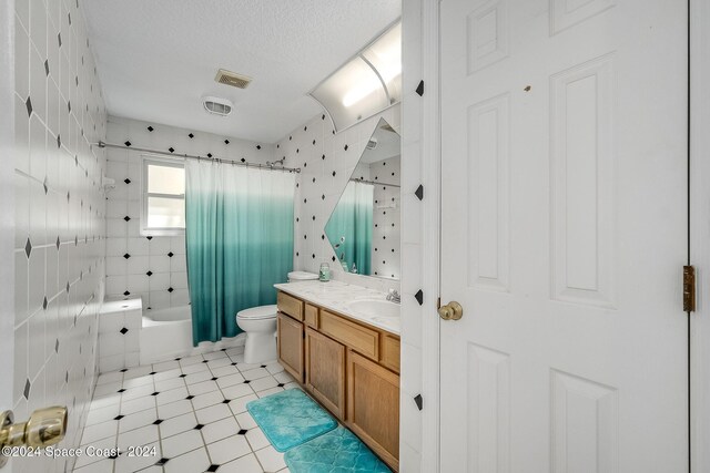 1165 Old Parsonage Dr, Merritt Island, FL 32952 - bathroom featuring vanity, toilet, shower / bath combination with curtain, and a textured ceiling