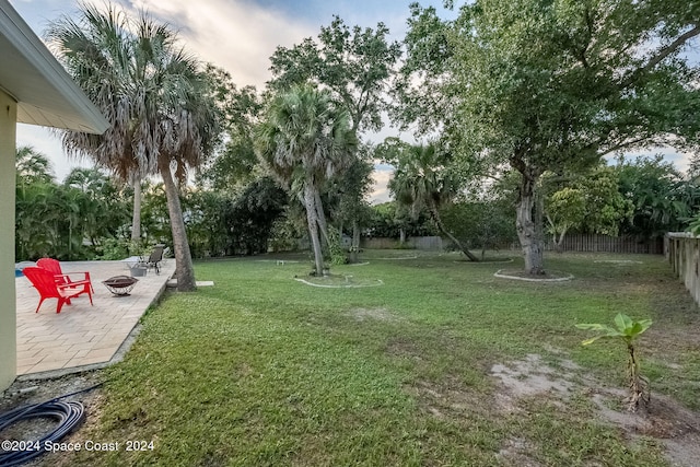 view of yard featuring a patio and a fire pit