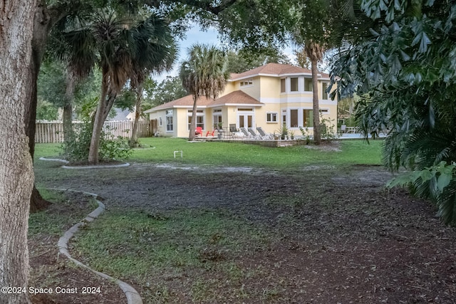 rear view of house featuring a yard