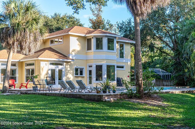 1165 Old Parsonage Dr, Merritt Island, FL 32952 - rear view of property featuring stucco siding, french doors, a yard, and a shingled roof