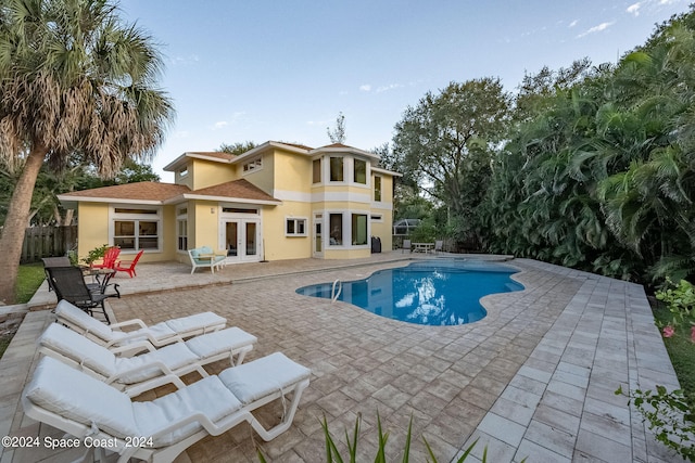 view of pool featuring french doors and a patio