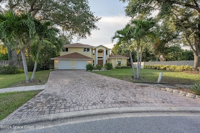 view of front facade featuring a front lawn, an outbuilding, and a garage