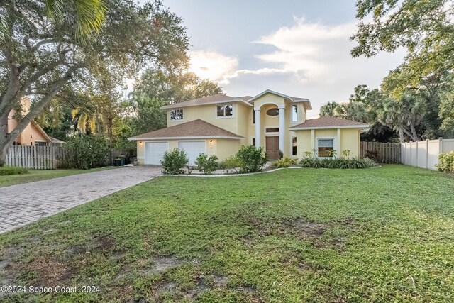 1165 Old Parsonage Dr, Merritt Island, FL 32952 - view of front of property with driveway, stucco siding, and an attached garage