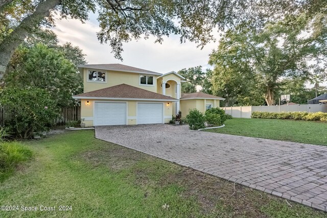 1165 Old Parsonage Dr, Merritt Island, FL 32952 - traditional-style house featuring stucco siding, decorative driveway, and an attached garage