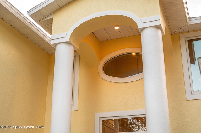 1165 Old Parsonage Dr, Merritt Island, FL 32952 - exterior view of stucco siding, ornate columns, and arched walkways